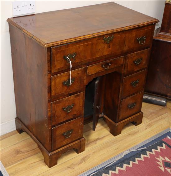A George I walnut kneehole desk, W.82cm. D.44cm, H.81cm